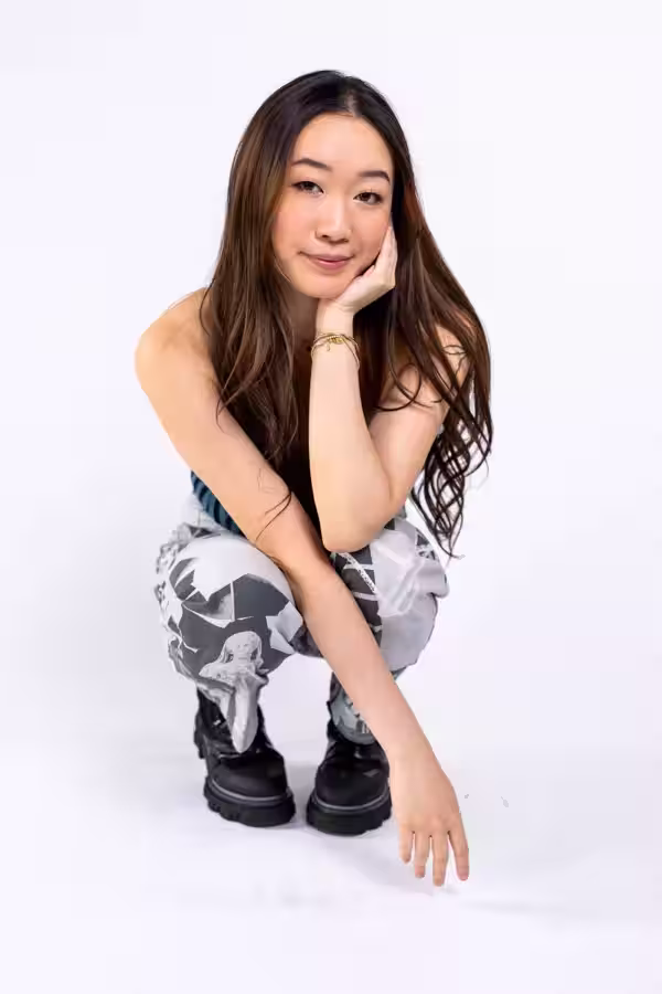 Charmy crouching on a white studio backdrop
